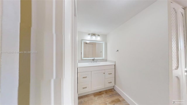 bathroom featuring vanity and hardwood / wood-style floors