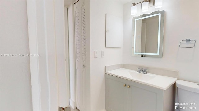 bathroom featuring vanity and toilet