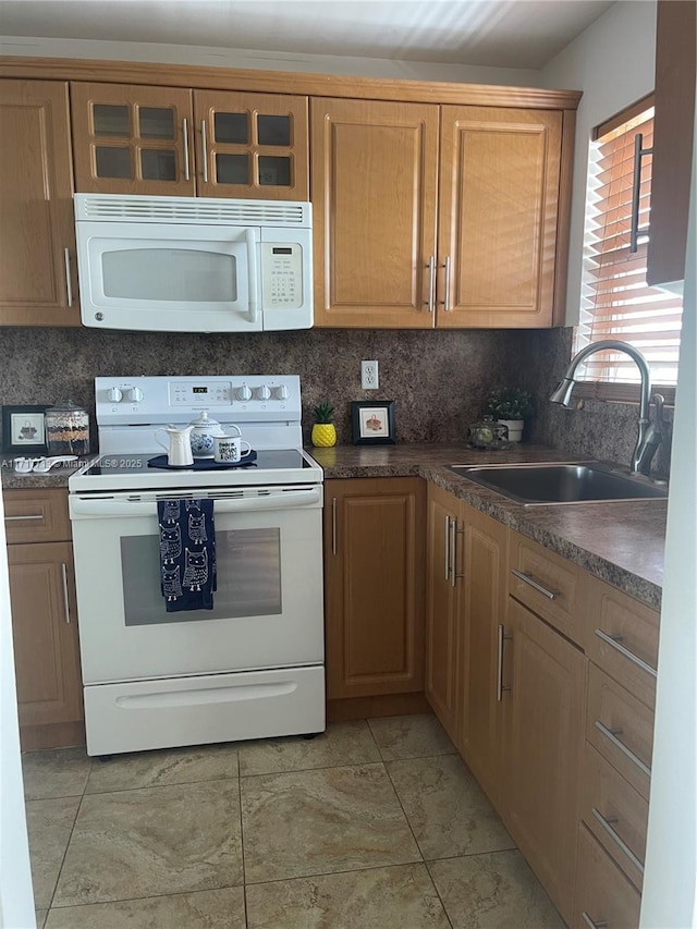 kitchen featuring light tile patterned flooring, white appliances, backsplash, and sink