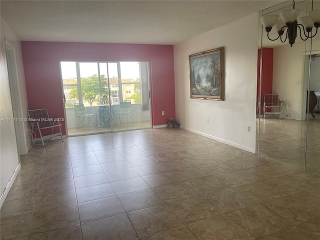 empty room featuring a notable chandelier