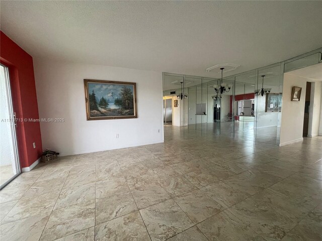 8345 Sunrise Lakes Blvd Unit 309, Sunrise, FL 33322 - spare room with baseboards and a textured ceiling