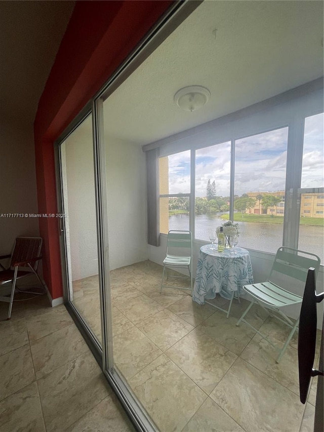 sunroom / solarium with a water view