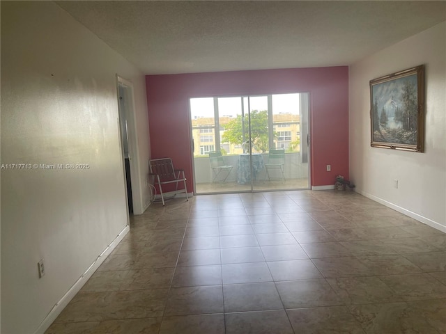 8345 Sunrise Lakes Blvd Unit 309, Sunrise, FL 33322 - tiled empty room with baseboards and a textured ceiling