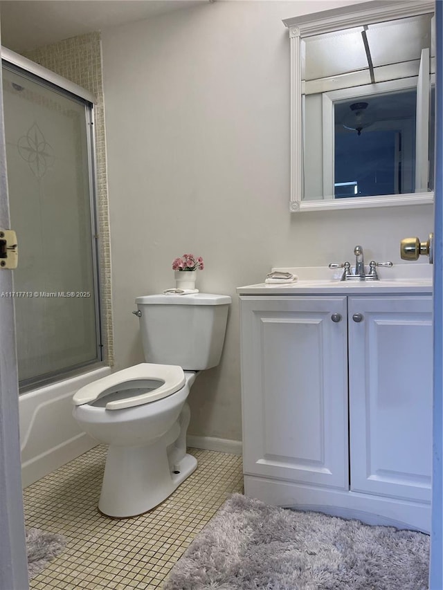 full bathroom with tile patterned floors, vanity, toilet, and enclosed tub / shower combo