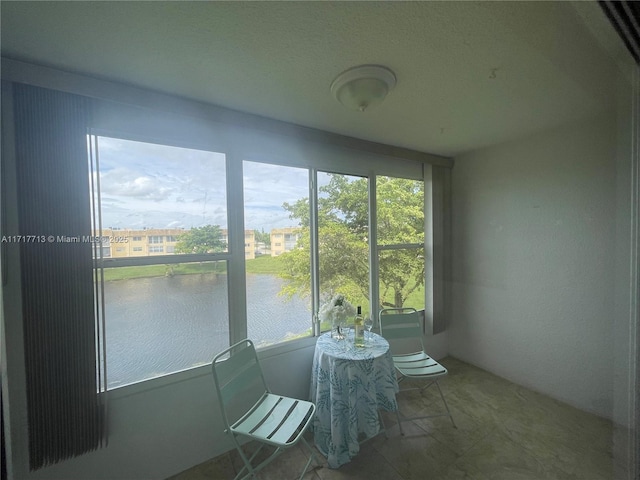 sunroom / solarium with a water view