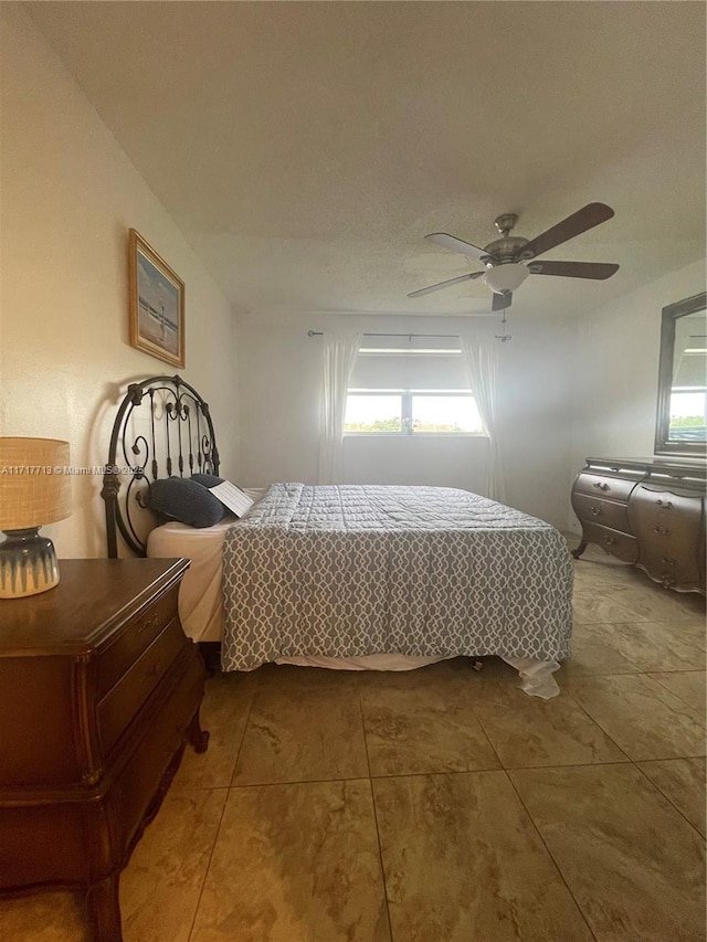 bedroom with tile patterned floors and ceiling fan