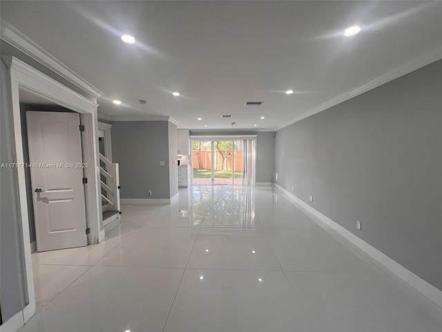 spare room with light tile patterned floors and crown molding