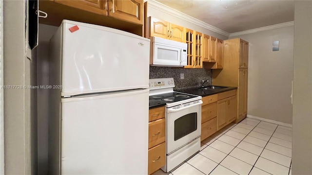 kitchen with backsplash, white appliances, crown molding, sink, and light tile patterned floors