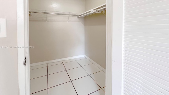 spacious closet with light tile patterned flooring