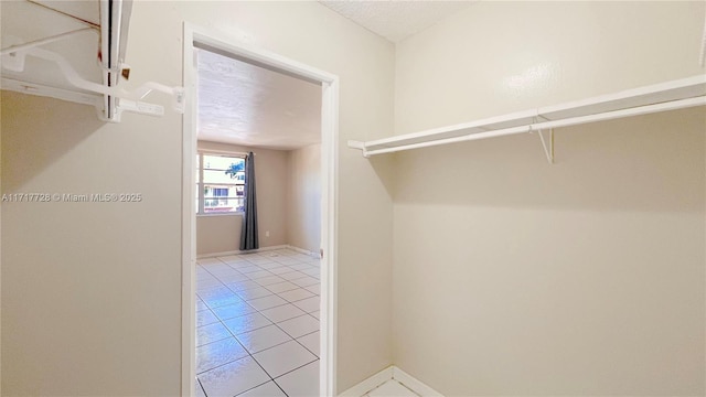 walk in closet featuring light tile patterned floors