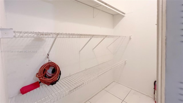 clothes washing area featuring tile patterned flooring