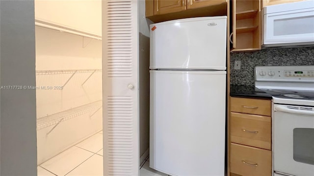 kitchen with white appliances and backsplash