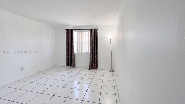 spare room featuring light tile patterned floors