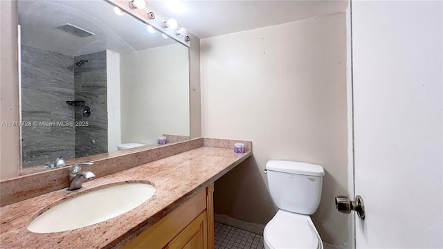 bathroom with tile patterned floors, a shower, vanity, and toilet