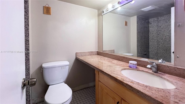 bathroom featuring tile patterned flooring, vanity, and toilet