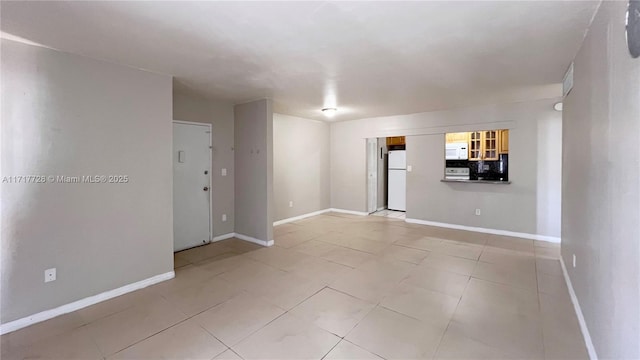 spare room featuring light tile patterned flooring