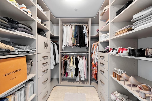 spacious closet featuring light tile patterned floors