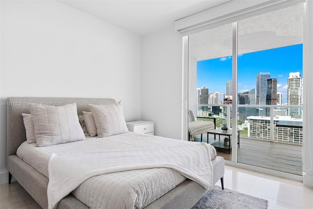 bedroom with access to exterior, light tile patterned floors, and multiple windows