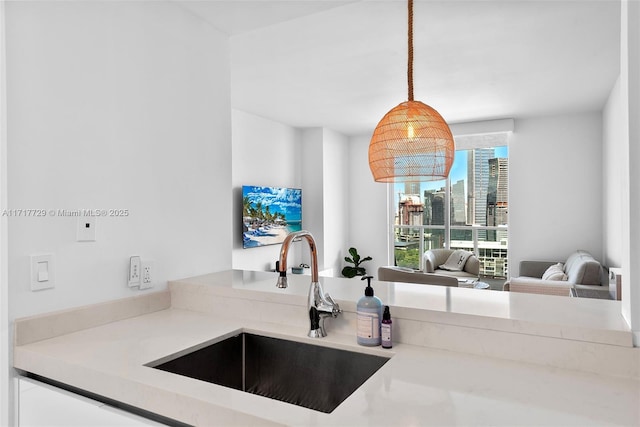 kitchen with decorative light fixtures and sink