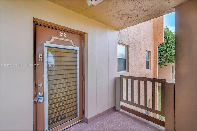 view of exterior entry with a porch