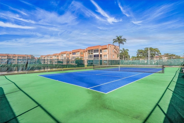 view of tennis court with basketball hoop