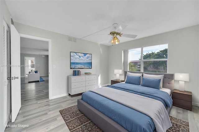 bedroom featuring a closet, light hardwood / wood-style flooring, and ceiling fan