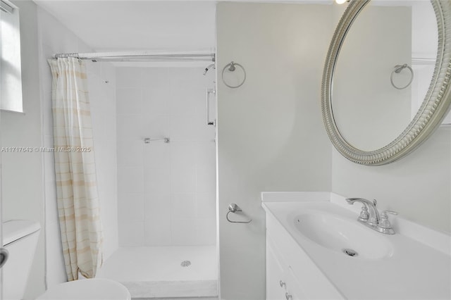 bathroom featuring vanity, toilet, and curtained shower