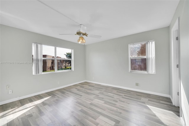 unfurnished room with ceiling fan and light hardwood / wood-style flooring