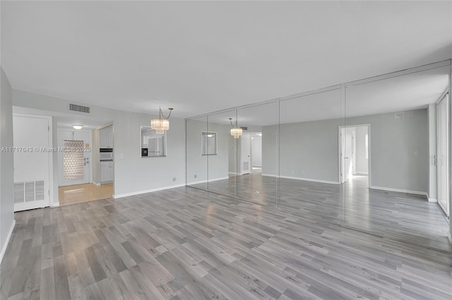 unfurnished living room featuring light wood-type flooring