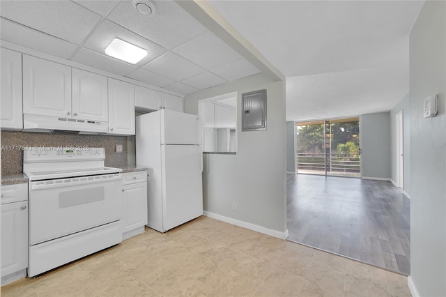 kitchen with electric range, white fridge, white cabinetry, and tasteful backsplash