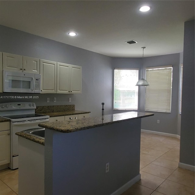 kitchen featuring a center island, white appliances, white cabinets, light tile patterned floors, and decorative light fixtures