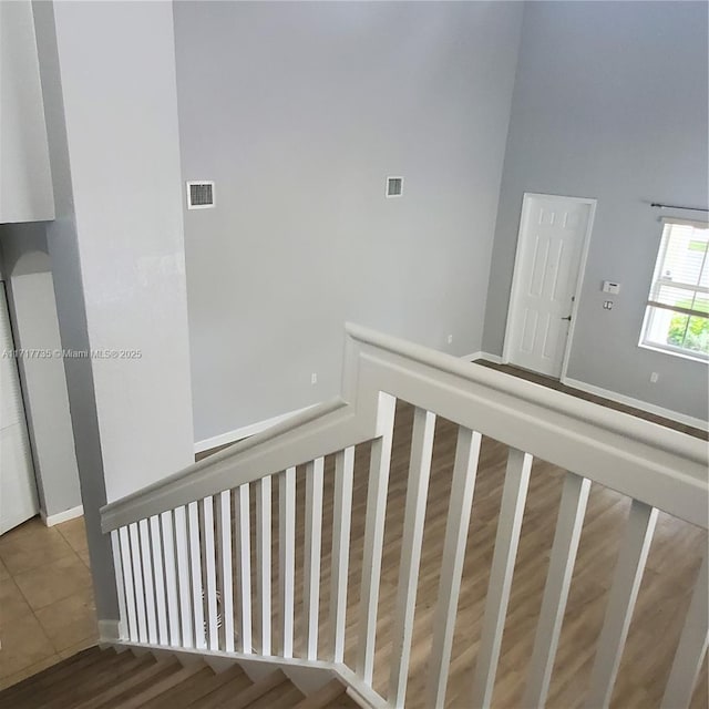 stairway featuring tile patterned flooring