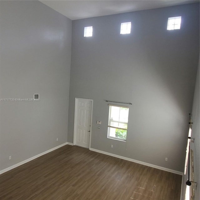 unfurnished room featuring dark wood-type flooring