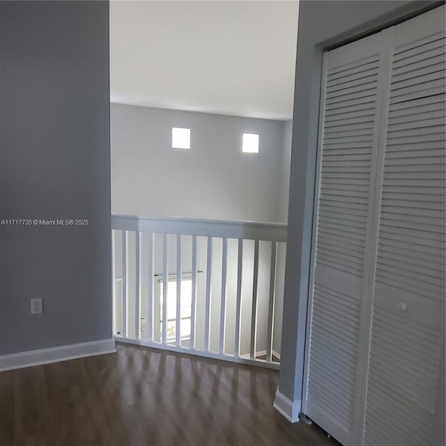 corridor featuring dark hardwood / wood-style flooring