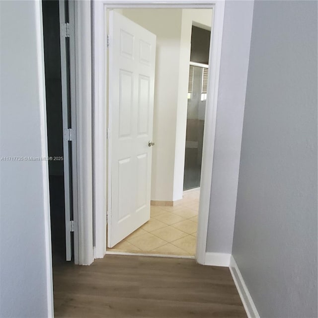 hallway with light tile patterned floors