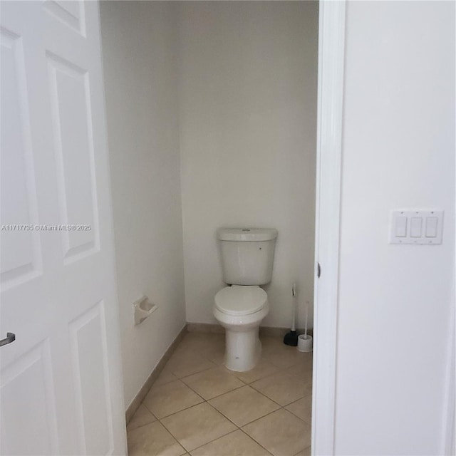 bathroom with tile patterned flooring and toilet