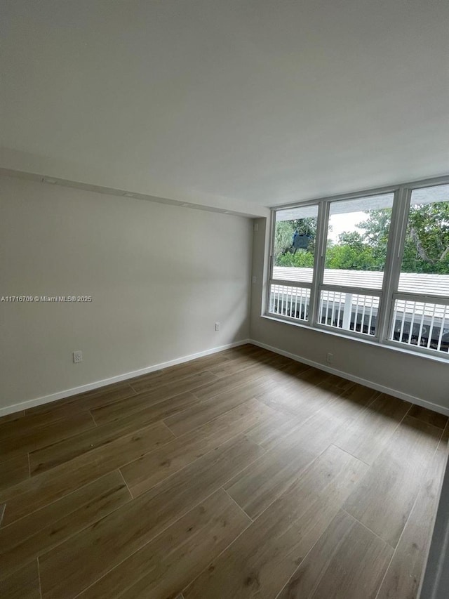 10230 Collins Ave Unit 102, Bal Harbour, FL 33154 - unfurnished room with dark wood finished floors and baseboards