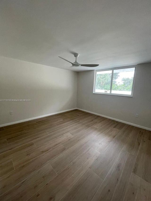 10230 Collins Ave Unit 102, Bal Harbour, FL 33154 - empty room with wood finished floors and ceiling fan