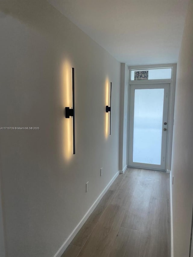 10230 Collins Ave Unit 102, Bal Harbour, FL 33154 - hallway with wood finished floors and baseboards