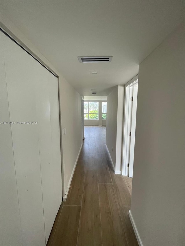 10230 Collins Ave Unit 102, Bal Harbour, FL 33154 - hall featuring dark wood-style floors and baseboards
