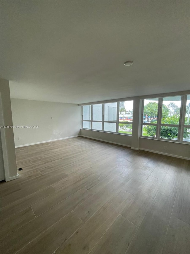 empty room with hardwood / wood-style floors