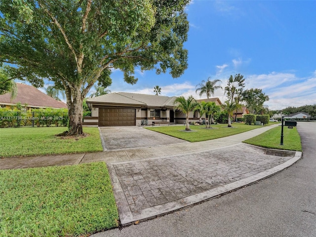 ranch-style house with a garage and a front yard