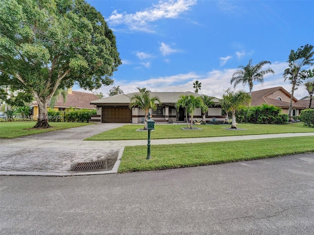 ranch-style home featuring a front lawn and a garage