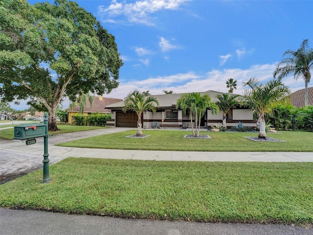 view of front facade with a garage and a front lawn