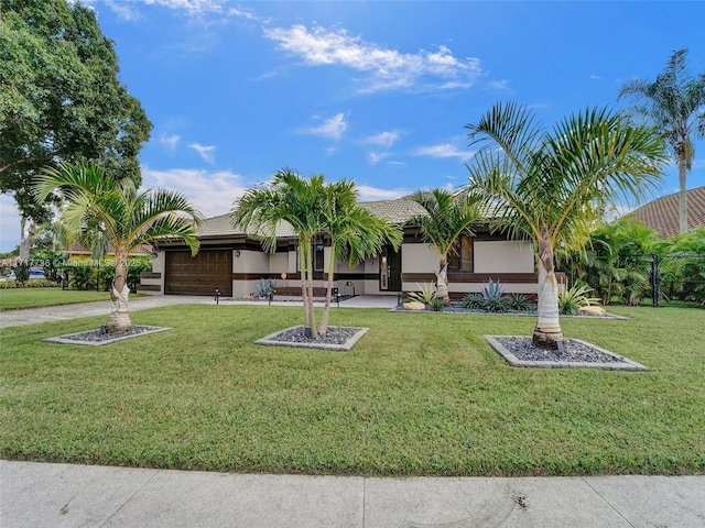 ranch-style home with a garage and a front lawn