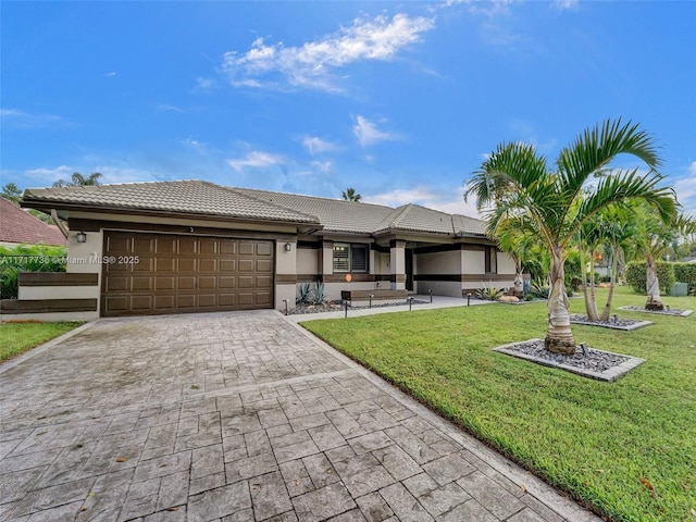 view of front of property featuring a garage and a front lawn