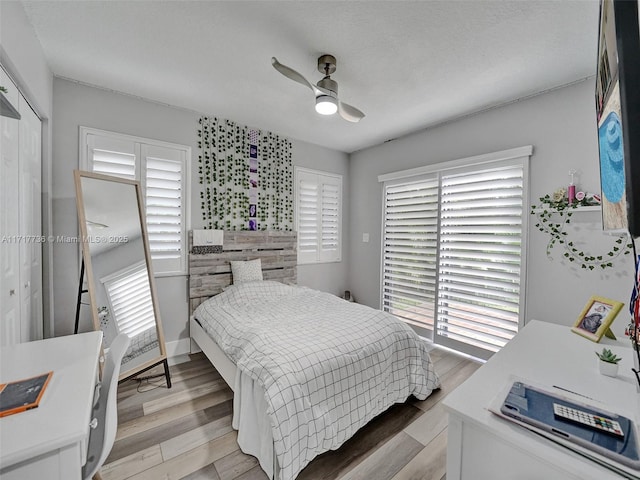 bedroom featuring a closet, light hardwood / wood-style floors, and ceiling fan