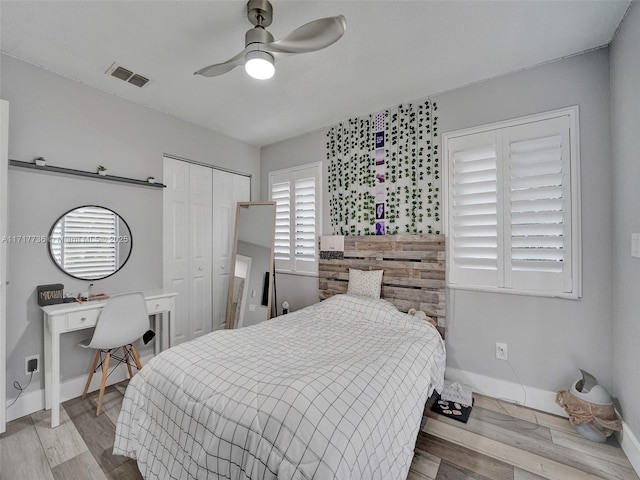 bedroom featuring a closet, light hardwood / wood-style flooring, and ceiling fan