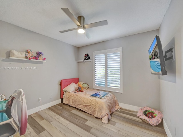 bedroom featuring ceiling fan and light wood-type flooring