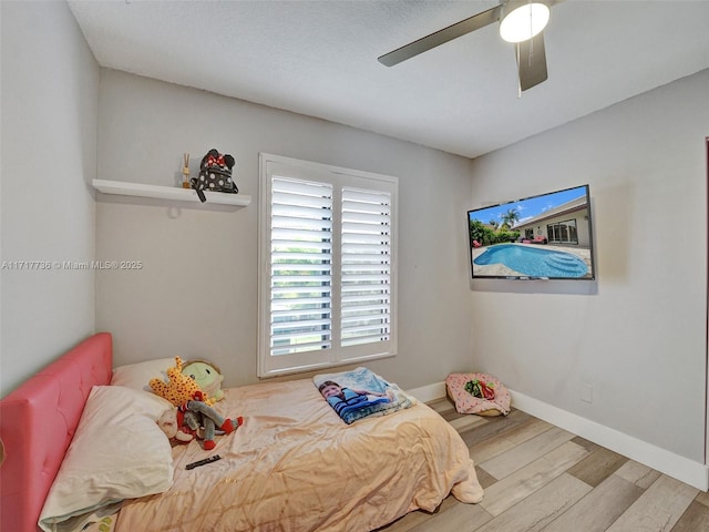 bedroom featuring wood-type flooring and ceiling fan